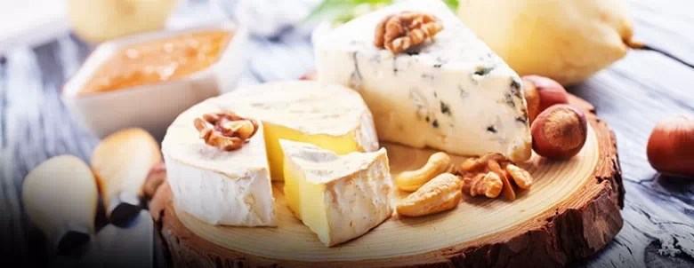 Selection of cheese on a round wooden board