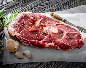 Slice of lamp before cooked with seasoning on top