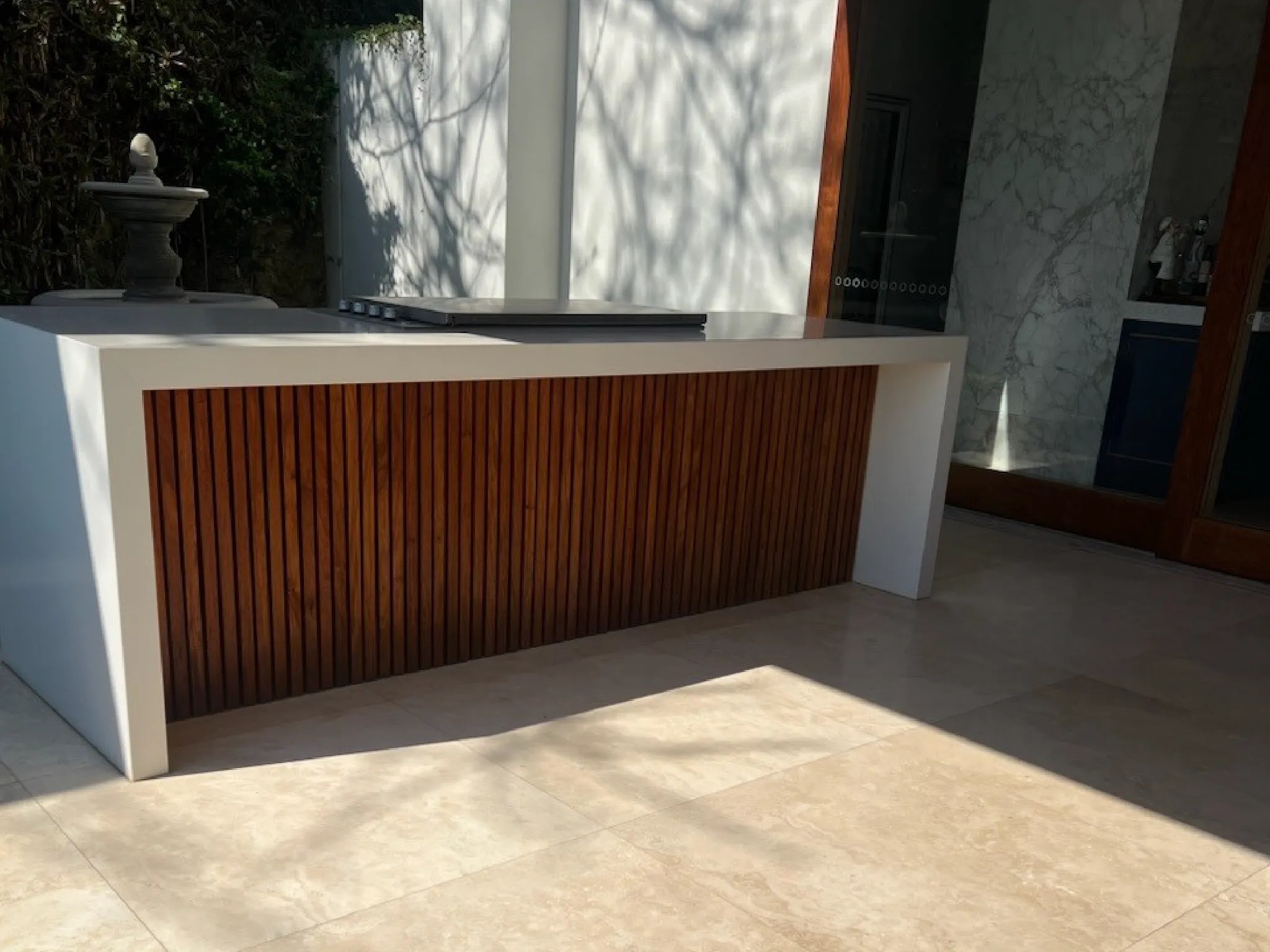 Rooftop deck featuring wooden flooring, a large planter, and a small pool area.