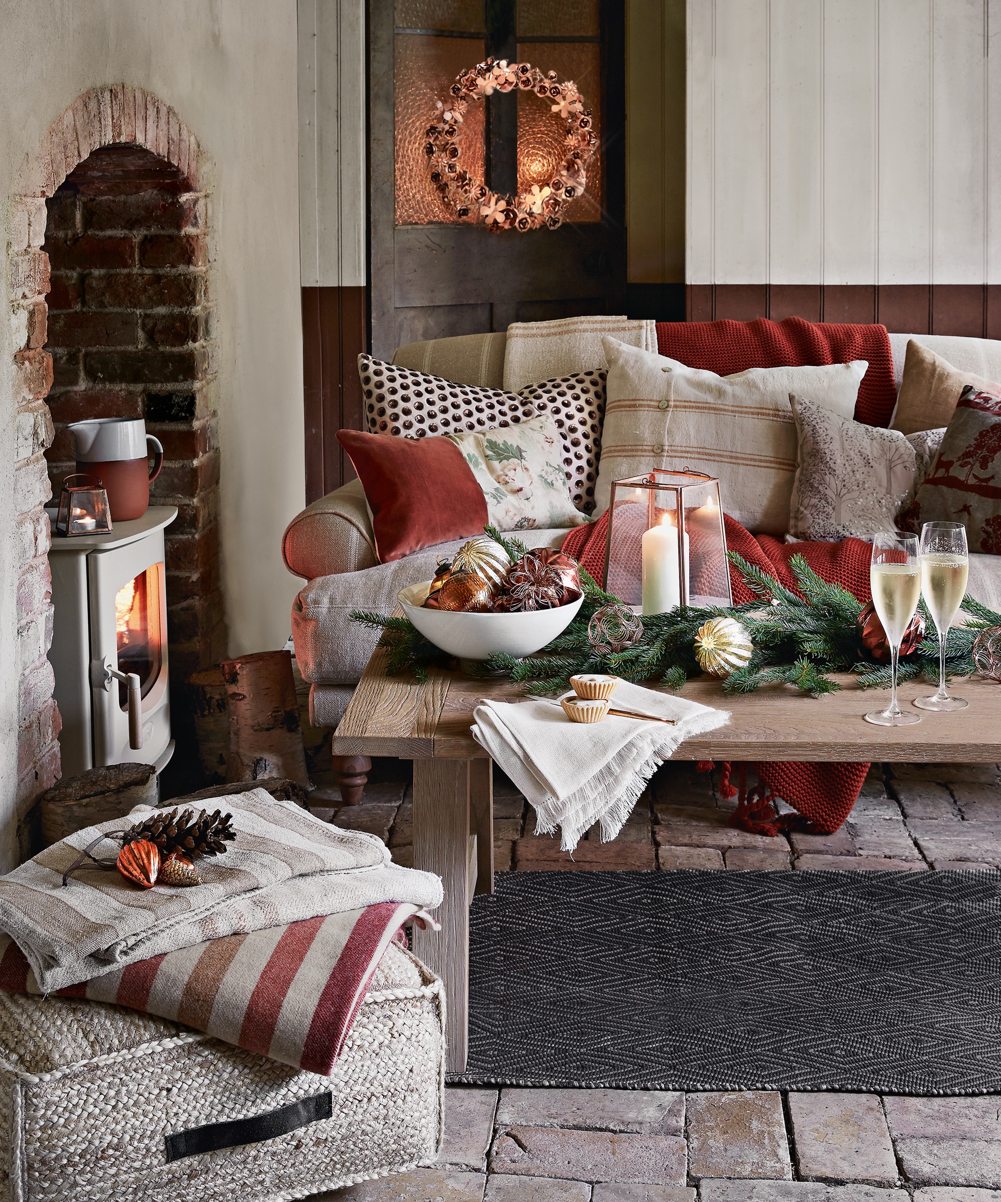 Pub orig. Living room, lit wood burning stove, sofa, assorted cushions