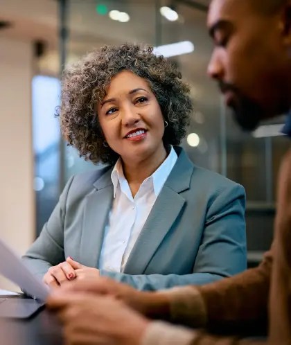 Happy financial consultant and African American man during a meeting in the office.