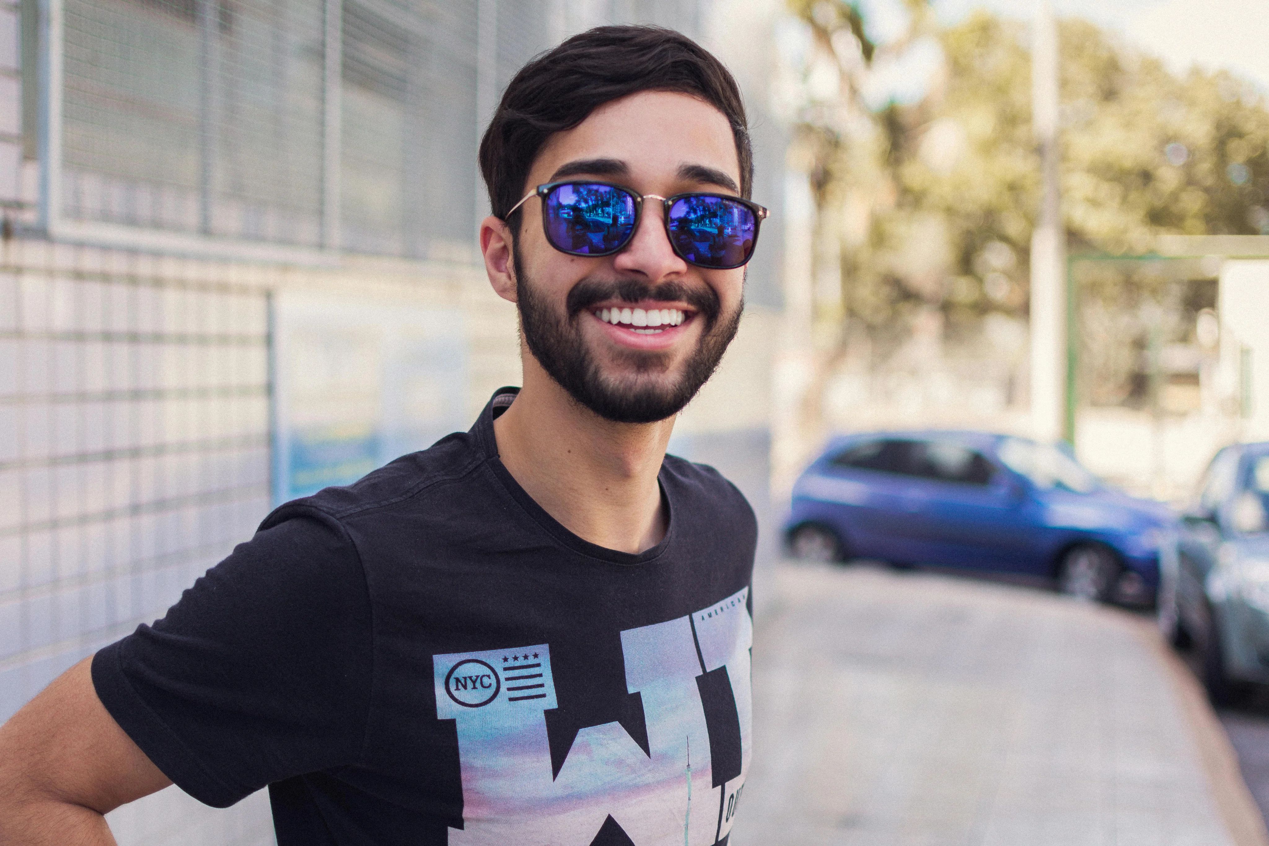 Young man in a black t-shirt with a cheerful expression.