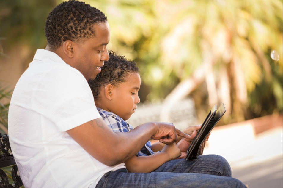 Father with his son using a tablet