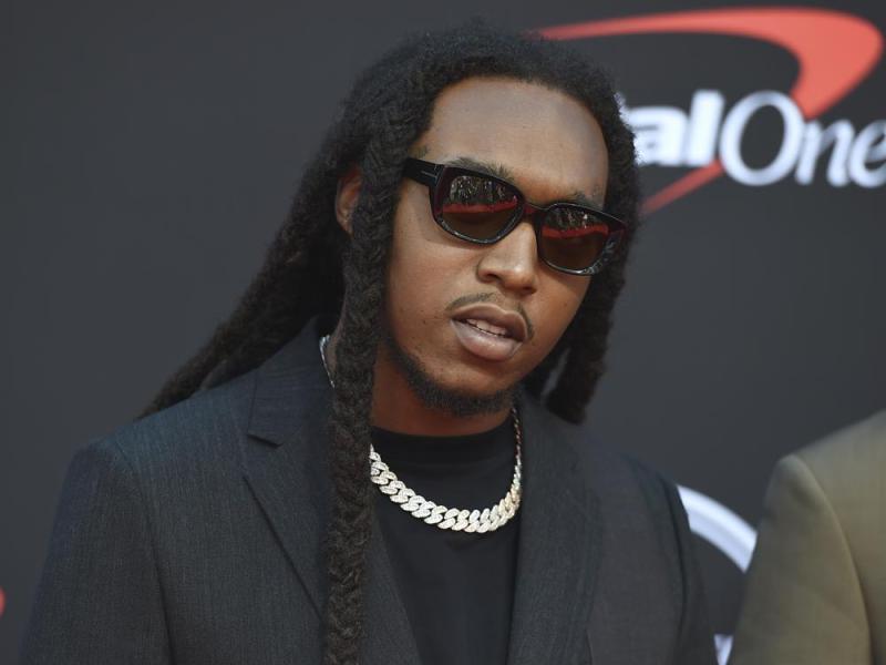 Takeoff taking pictures behind Capital One backdrop