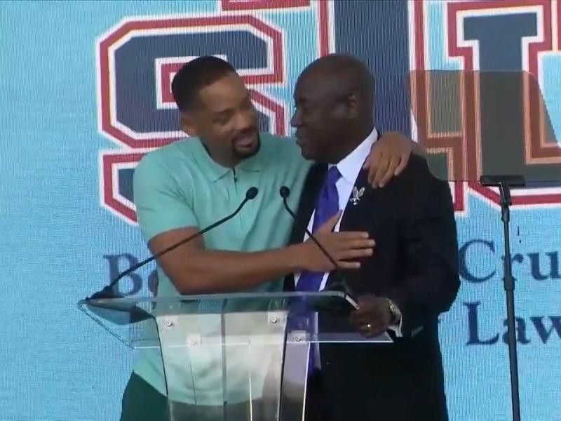 Will Smith congratulates Attorney Benjamin Crump during law school renaming ceremony. Screen grab, WSVN 7News Miami.