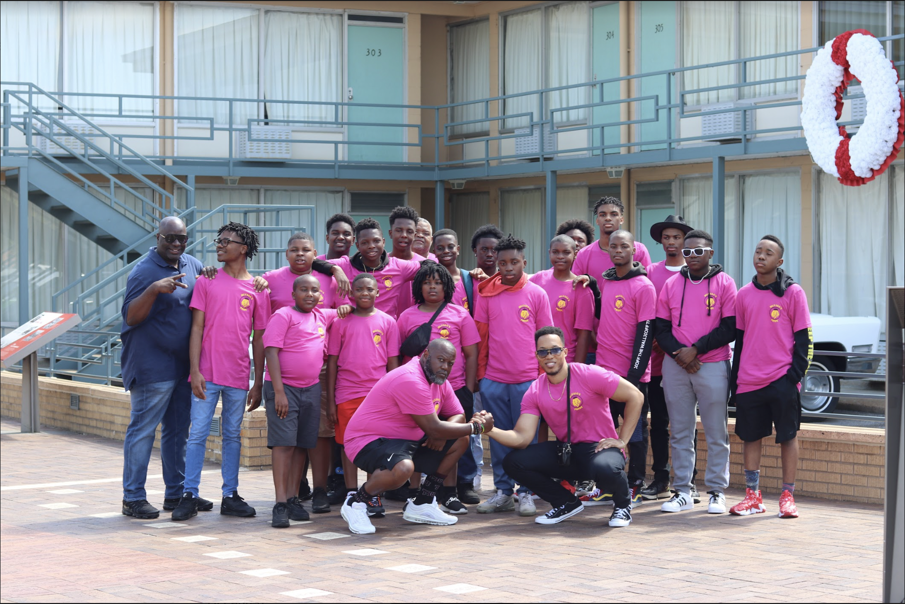 Group of teen boys and men pose at the National Civil Rights Museum in Memphis.