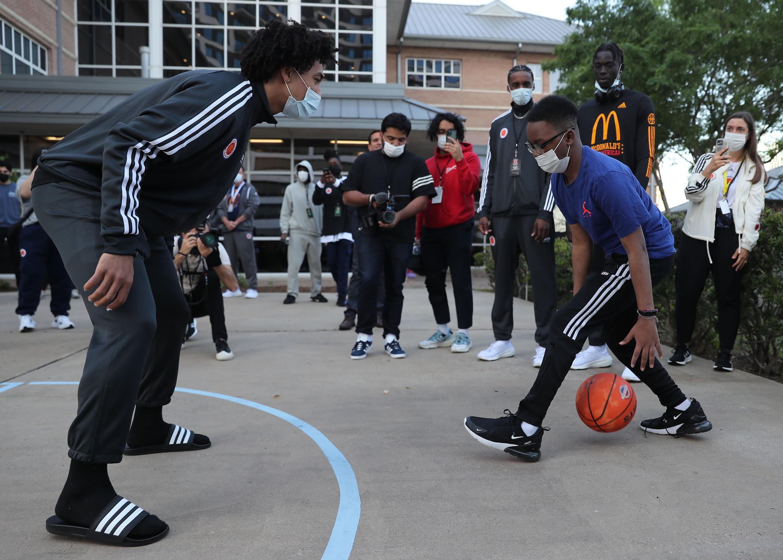 One of the 2023 McDonald’s All-American boys team members just before getting crossed over by one of the Ronald McDonald House Houston residents