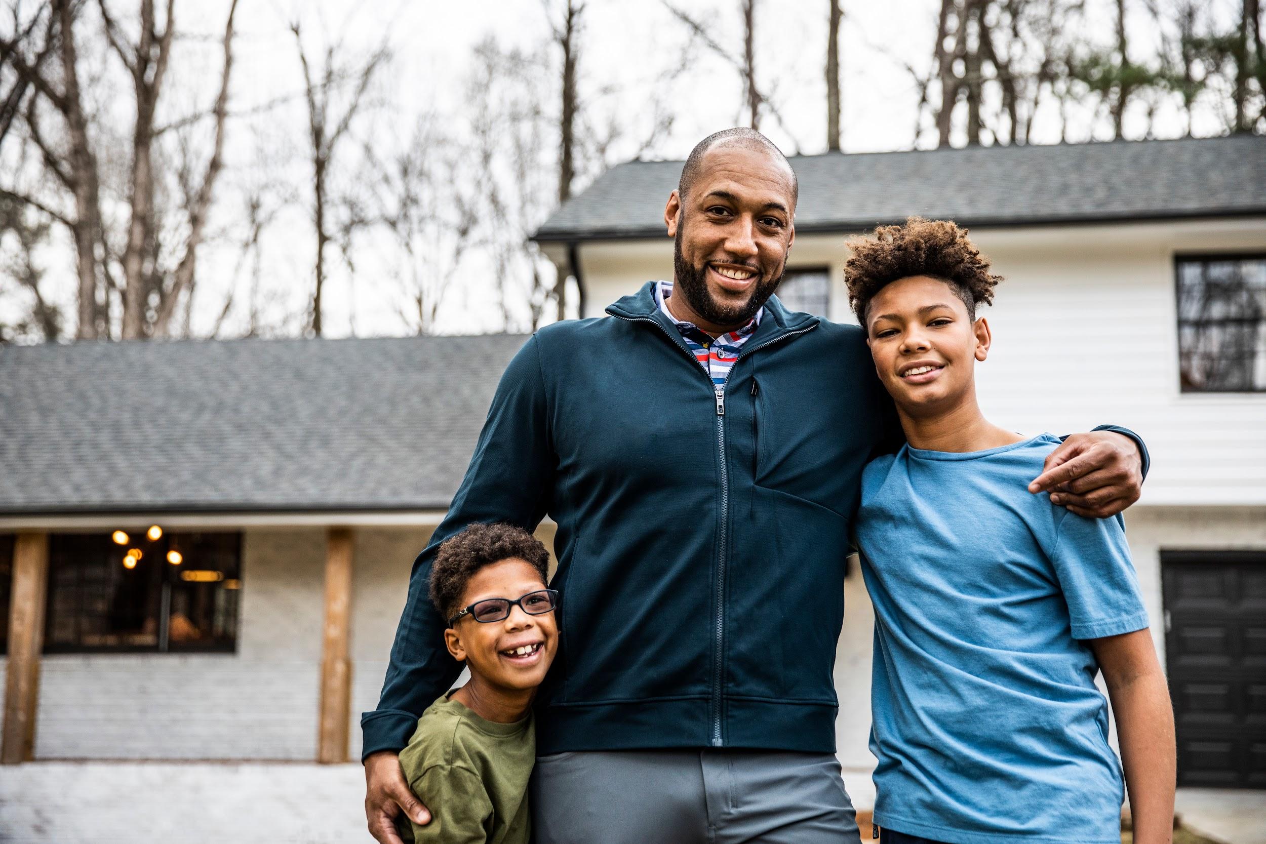 a father standing with two sons