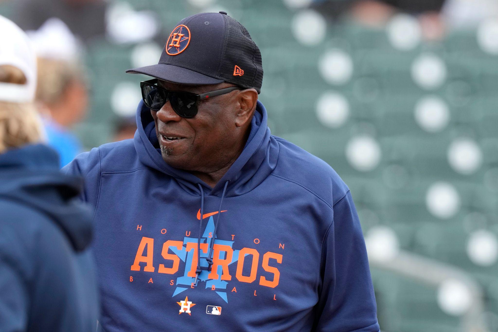 Astros manager Dusty Baker in a blue fleece jacket with the word Astros in orange font.