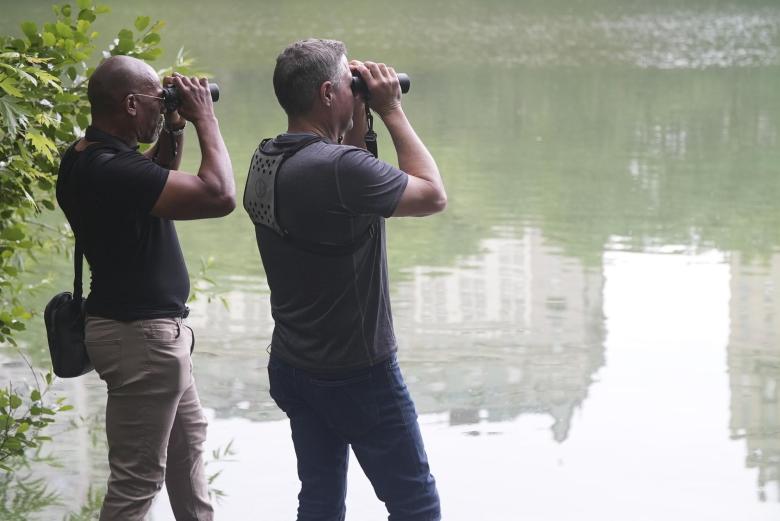 Christian Cooper, left, and biologist - wildlife conservationist Jeff Corwin, lookin through binoculars.
