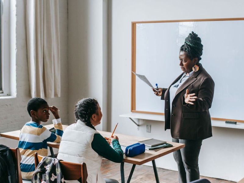 A teacher with children in a classroom.