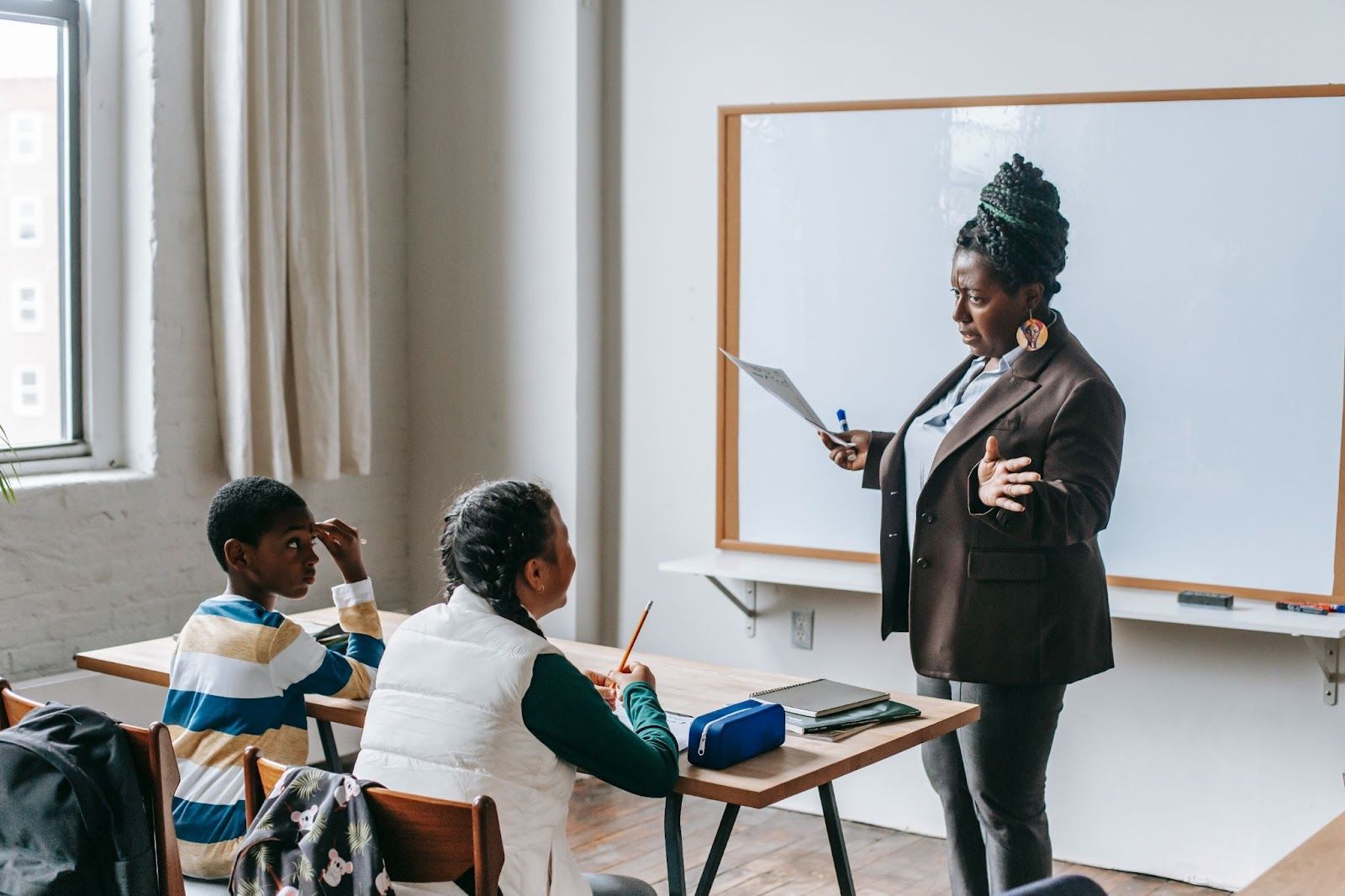 A teacher with children in a classroom.