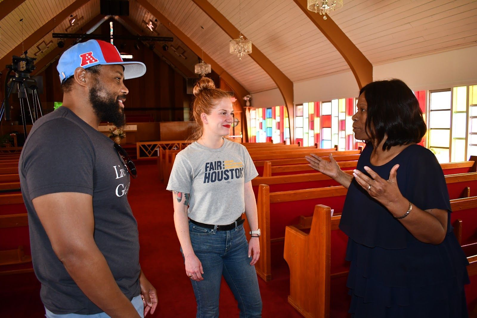 Fair for Houston organizer Molly Cook (center) converses with Pastor Howard Lee Thomas (left).