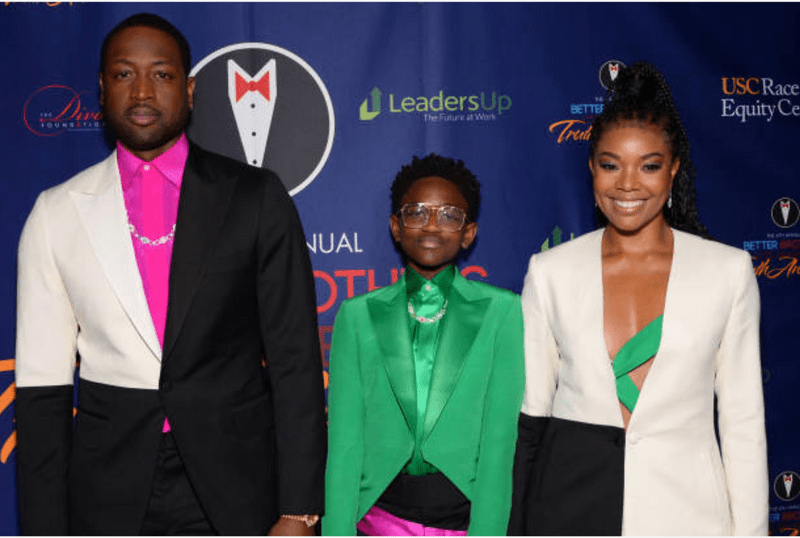 NBA Legend Dwayne Wade takes a photo with his daughter and wife.