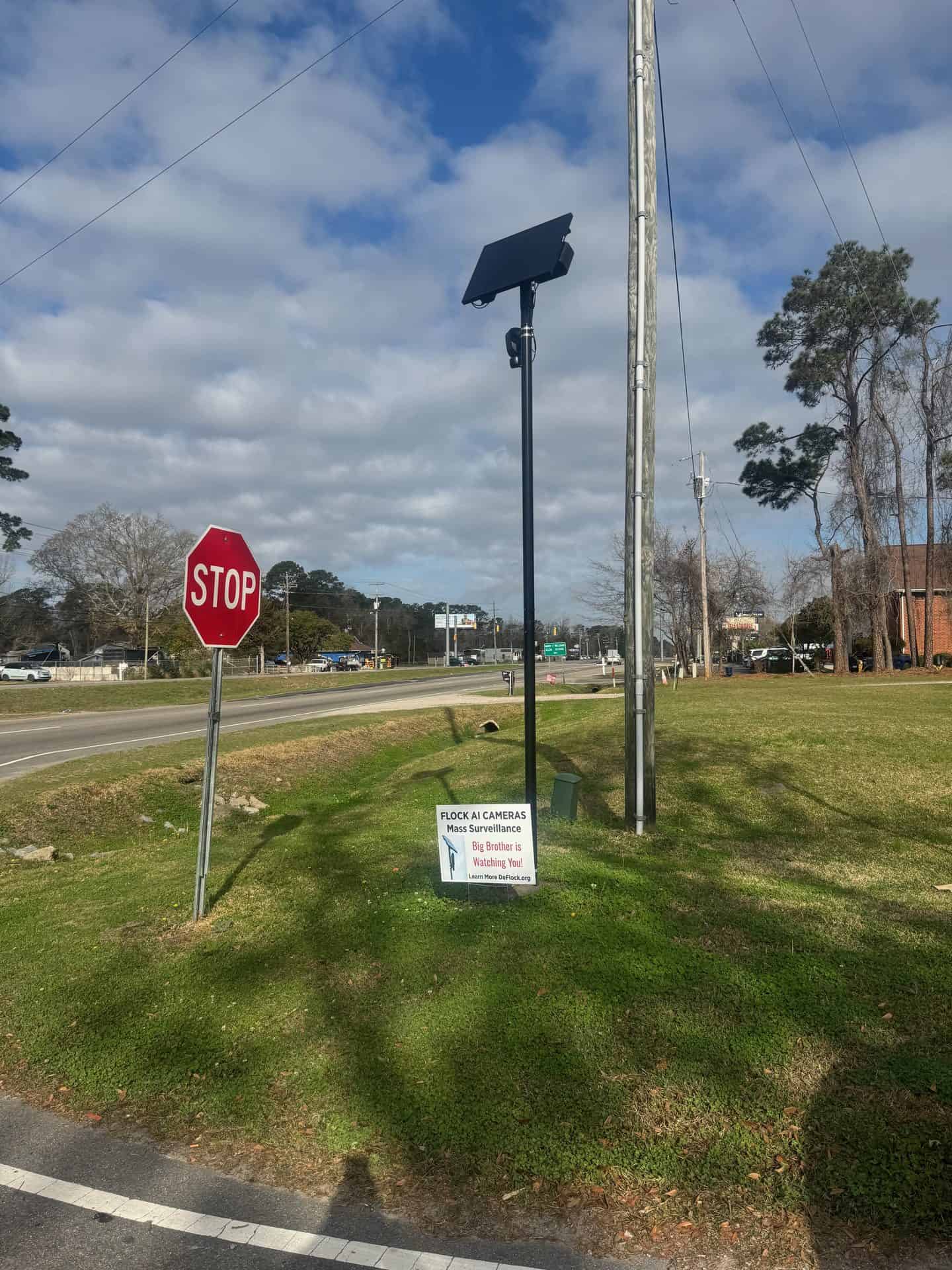 Flock camera beside a stop sign at a Carolina Beach Road intersection in Wilmington