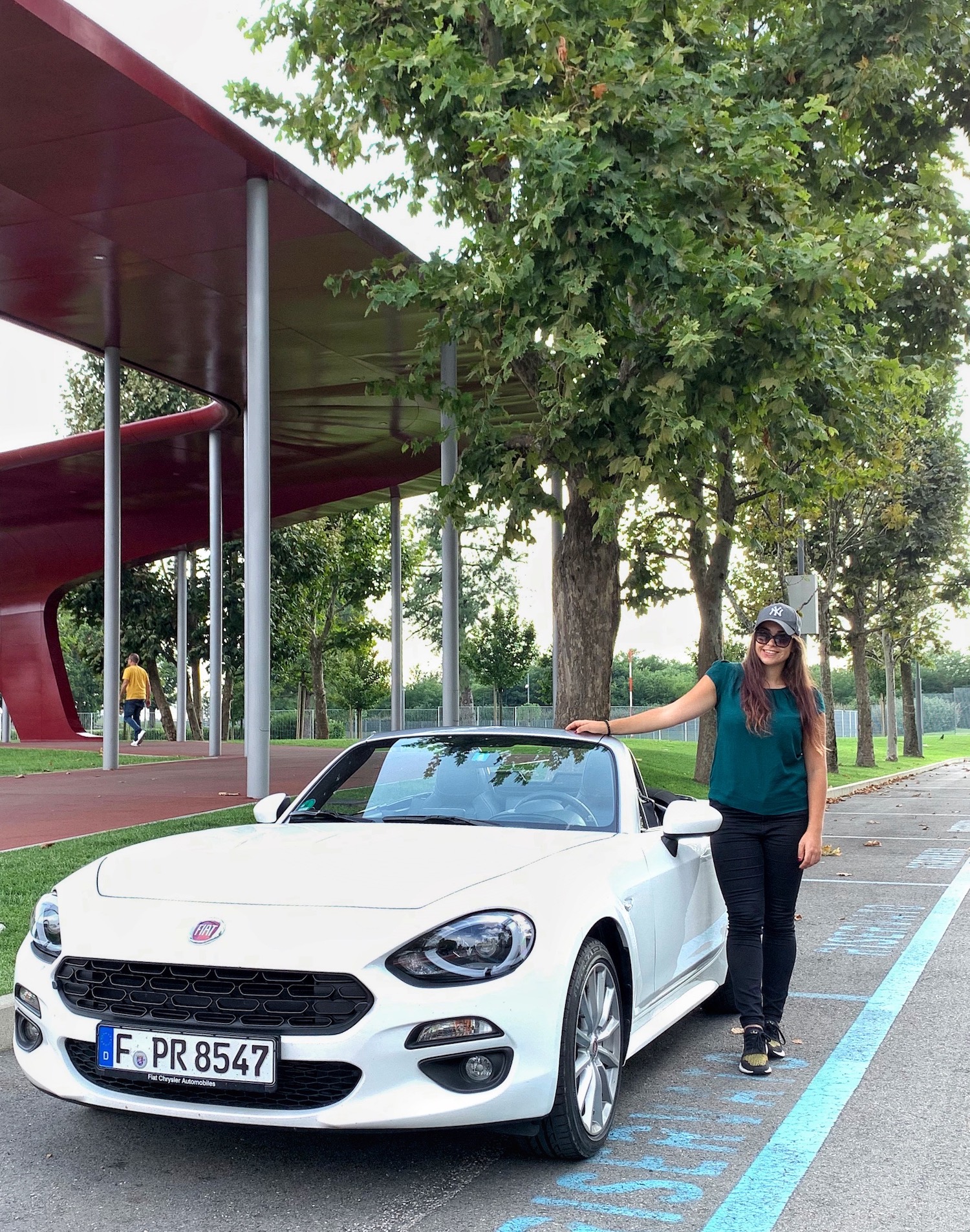 Elisa Artioli with the Fiat 124 spider in front of the Alfa Museum in Italy