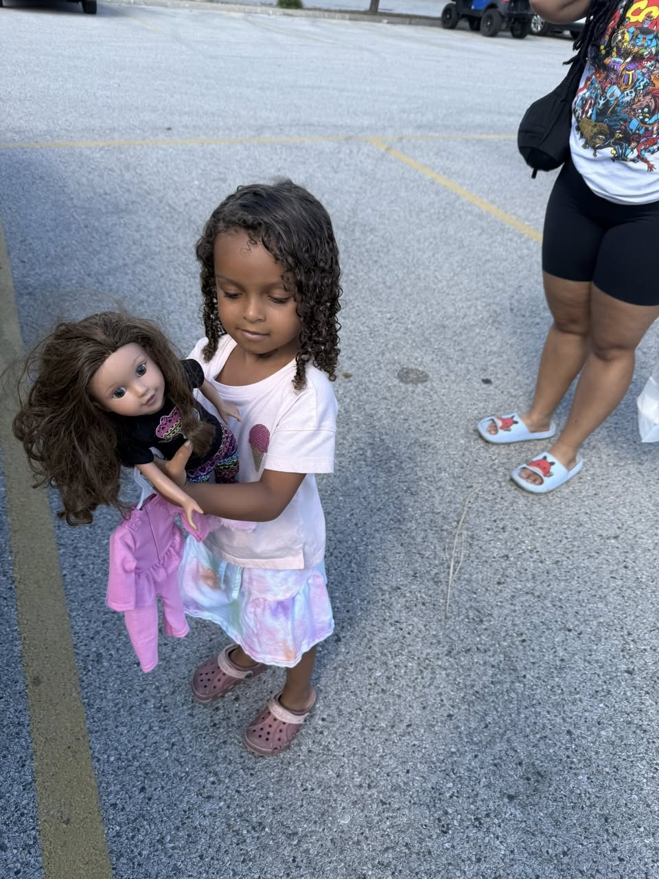 Family photo of a small human child holding a doll.