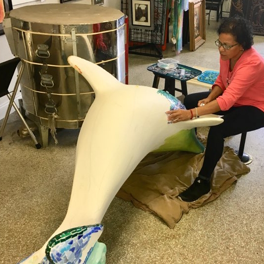 Dee placing one piece of glass at a time.