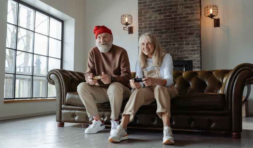 man and woman sitting on brown leather couch