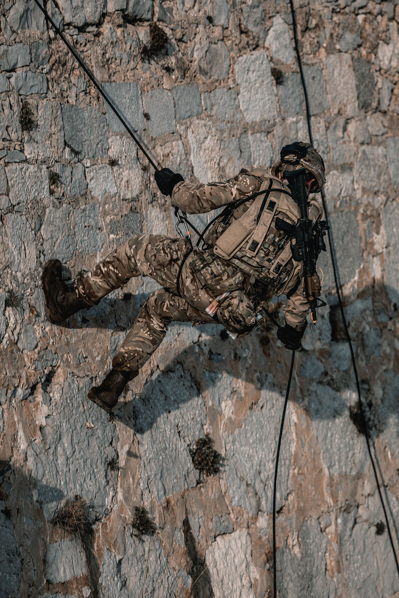 ROYAL MARINES OF 43 COMMANDO TRAIN ON THE FAMOUS ROCK OF GIBRALTAR Pictured: Royal Marines of P Squadron, 43 Commando, conduct Vertical Assault training under the watchful eye of Mountain Leaders, the Royal Marines mountain warfare specialists, in preparation for cliff assaults and abseil extractions that will be conducted at night later in the exercise. Royal Marines from Scotland-based 43 Commando Fleet Protection Group have taken part in demanding training exercises on, and within, the Rock of Gibraltar, perfecting techniques they use in their top-secret mission as the elite guardians of the United Kingdom’s strategic nuclear deterrent. Over 80 of these highly trained Commandos spent 2 weeks in early November on Exercise Serpent Rock honing the skills necessary for their no-fail mission protecting the Nation’s nuclear assets. This annual exercise sees the Royal Marines making best use of Gibraltar’s unique terrain, undertaking amphibious and cliff assaults, close quarter battle in urban environments and within the network of tunnels the Rock is famous for, as well as patrolling its streets, thoroughfares and the narrow alleyways and passages that pepper this British overseas territory.