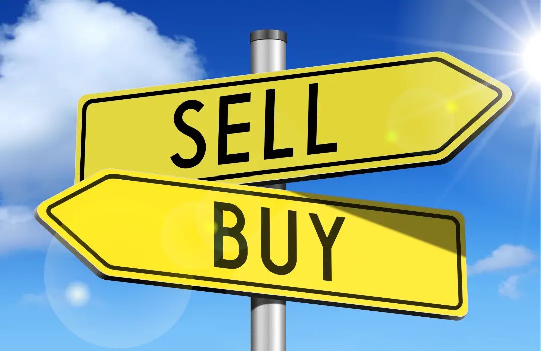 Two bright yellow directional signs labeled “Sell” and “Buy” pointing in opposite directions against a blue sky, representing the decision to buy or sell a home.