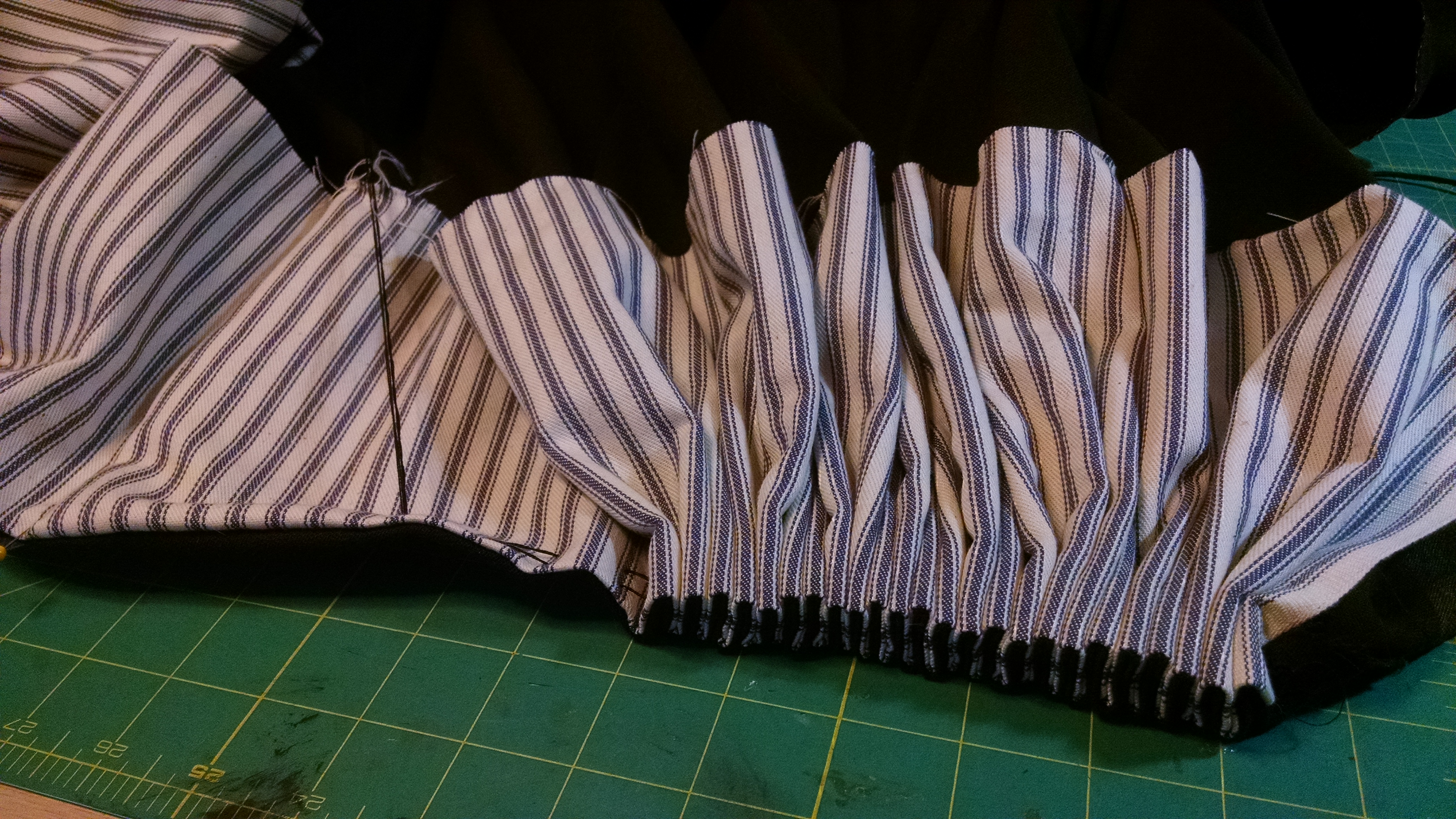 Pulling the pleats tight.