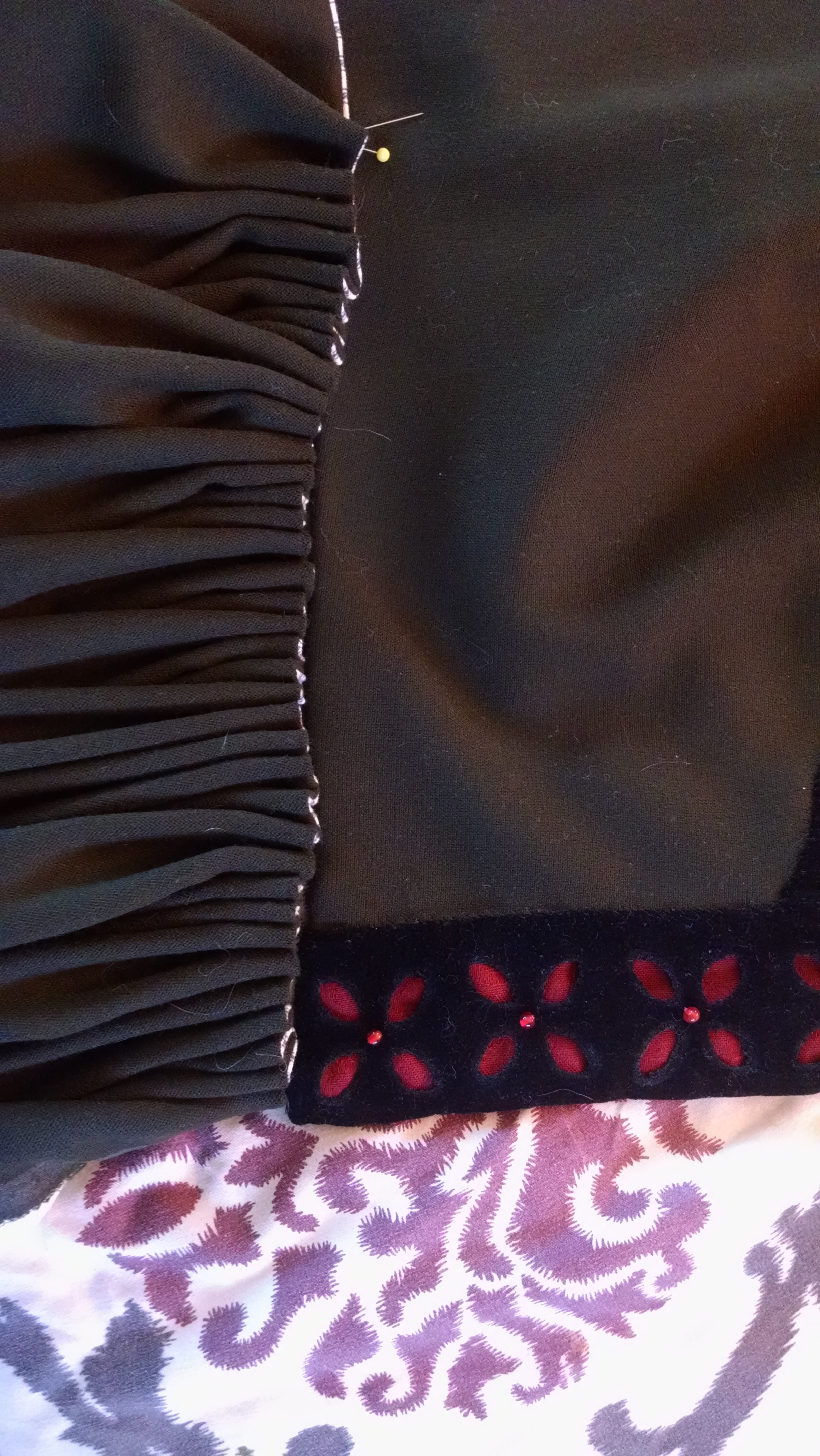 Sewing down the pleats to the bodice.