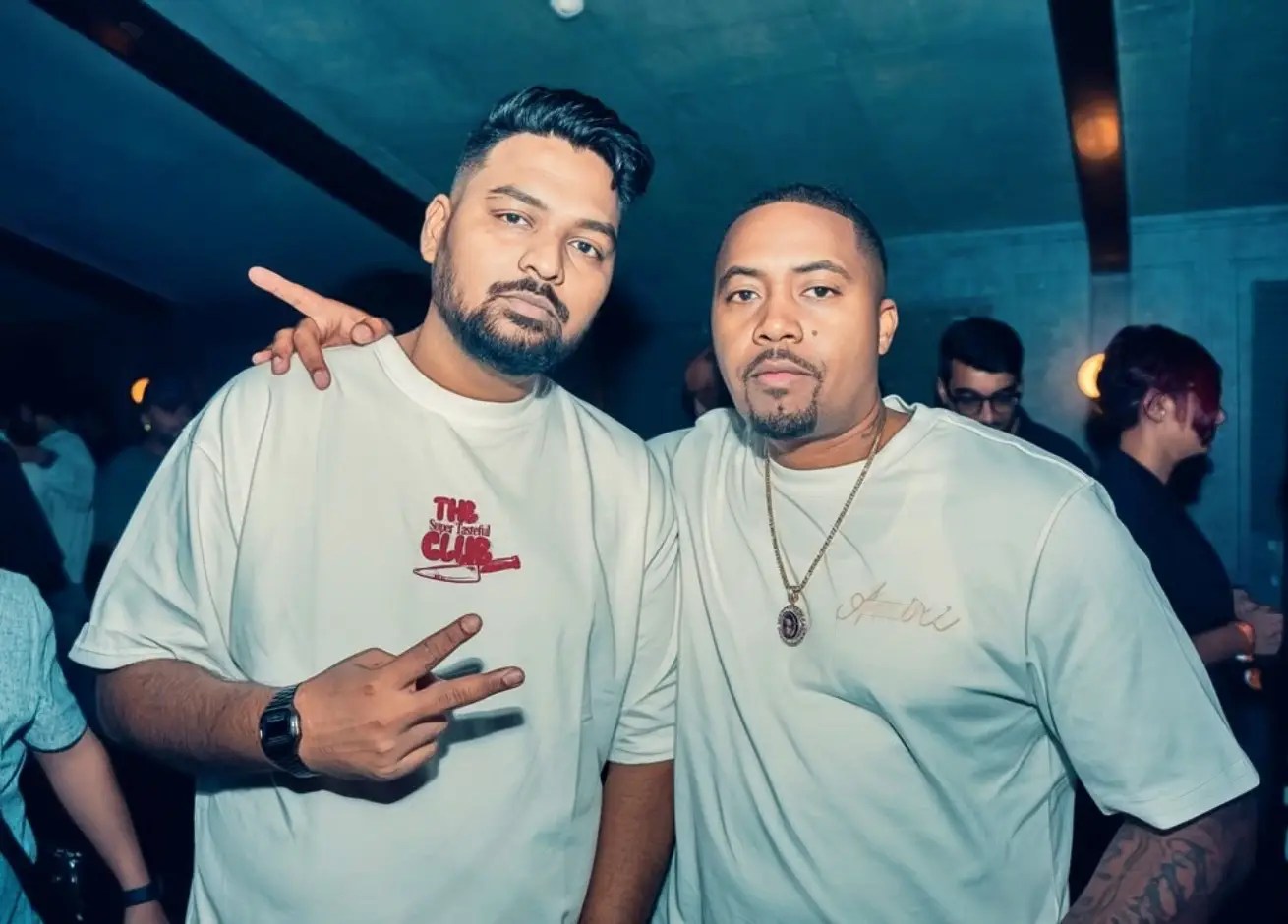 DJ Proof standing with Nas at a hip hop event – Indian DJ and global rap legend together