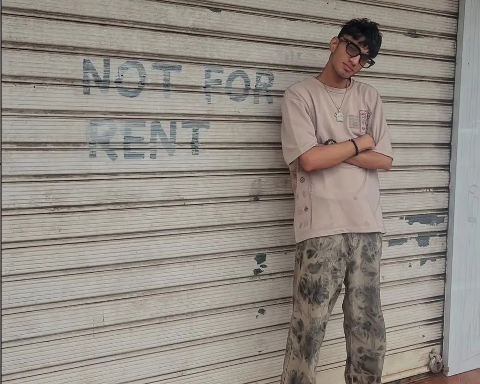 Sahaj standing in front of a shutter with ‘Not For Rent’ painted on it, photo for his Desi Renaissance interview about Spit Dope and Indian battle rap