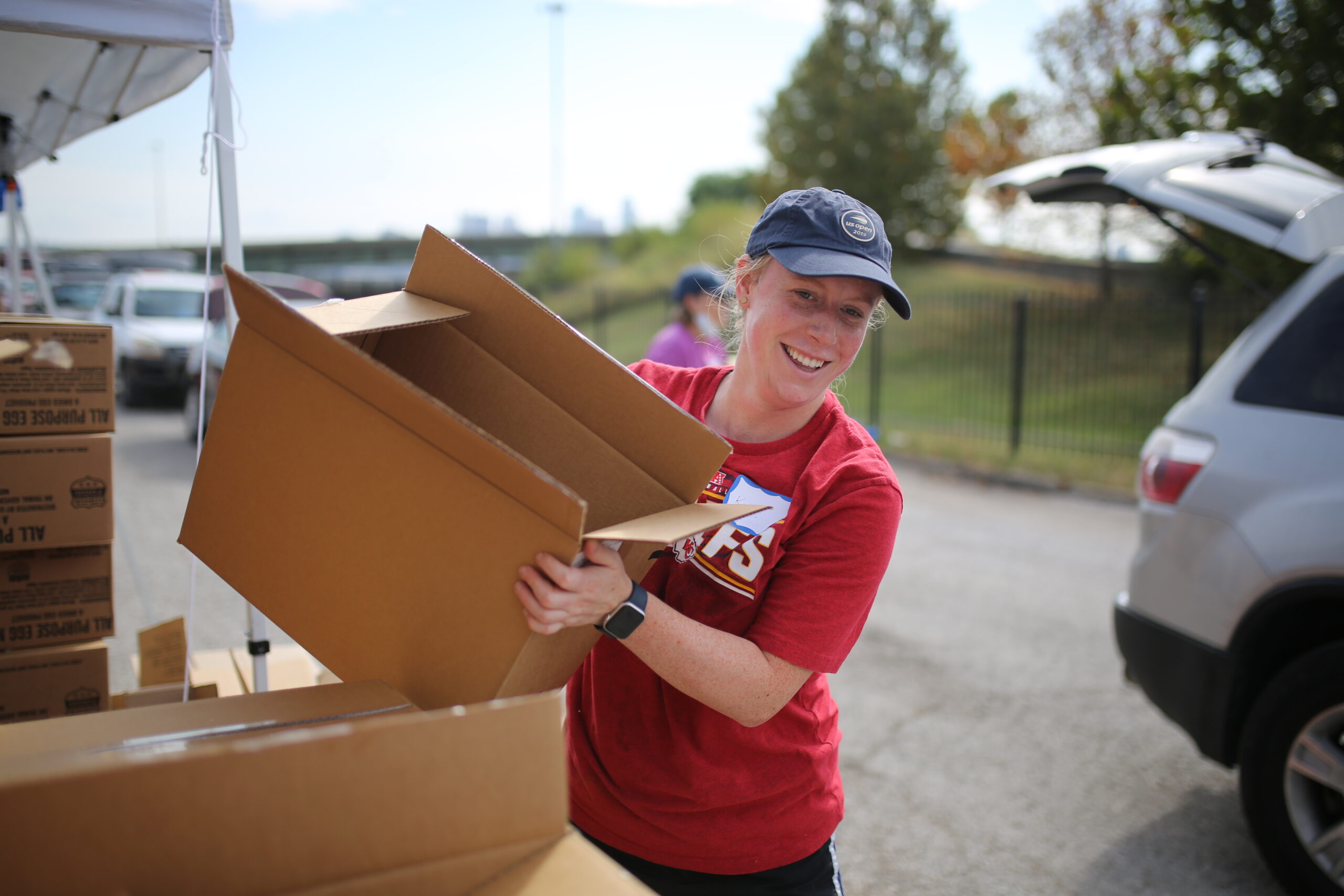 Volunteer carrying a box at a Mobile Food Distribution event.