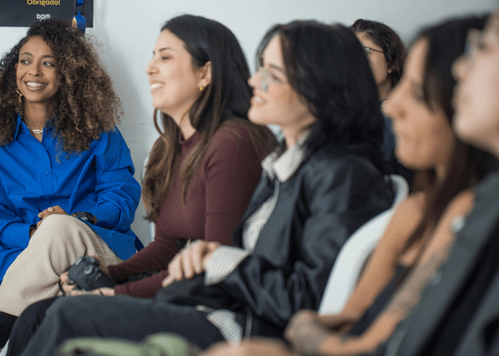 improve L&D feature with woman smiling to the front of a room
