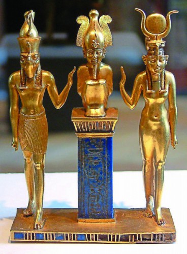 The family of Osiris at Louvre museum in Paris. Osiris on a lapis lazuli pillar in the middle, flanked by Horus on the left and Isis on the right.