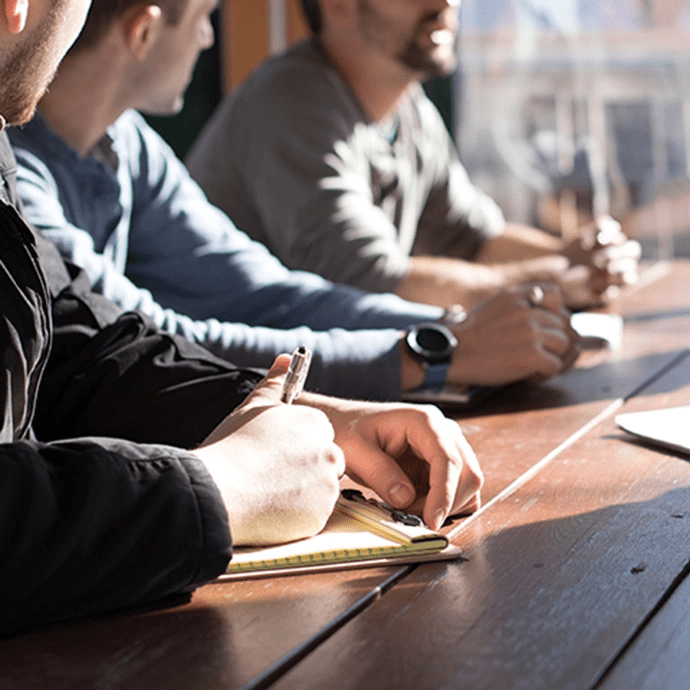 Attorneys and clients collaborating at a meeting table — business law and legal counsel in Denver, Colorado.
