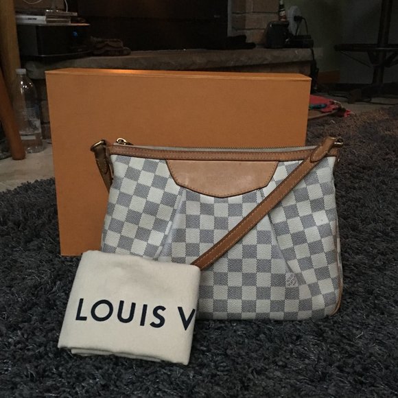 This coated canvas bag features brass hardware, a single adjustable cross body strap, tan vachetta leather . Louis Vuitton Bags | Louis Vuitton Siracusa Pm | Poshmark