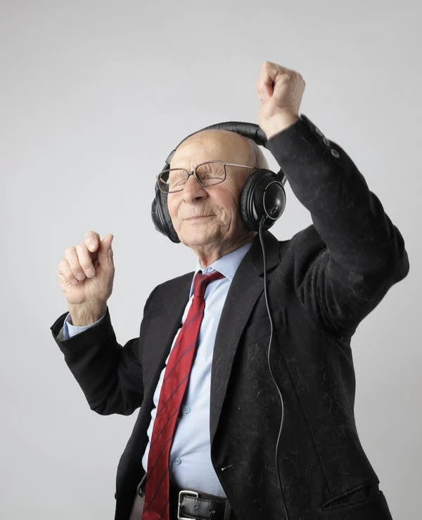 old man in headphones dancing to himself