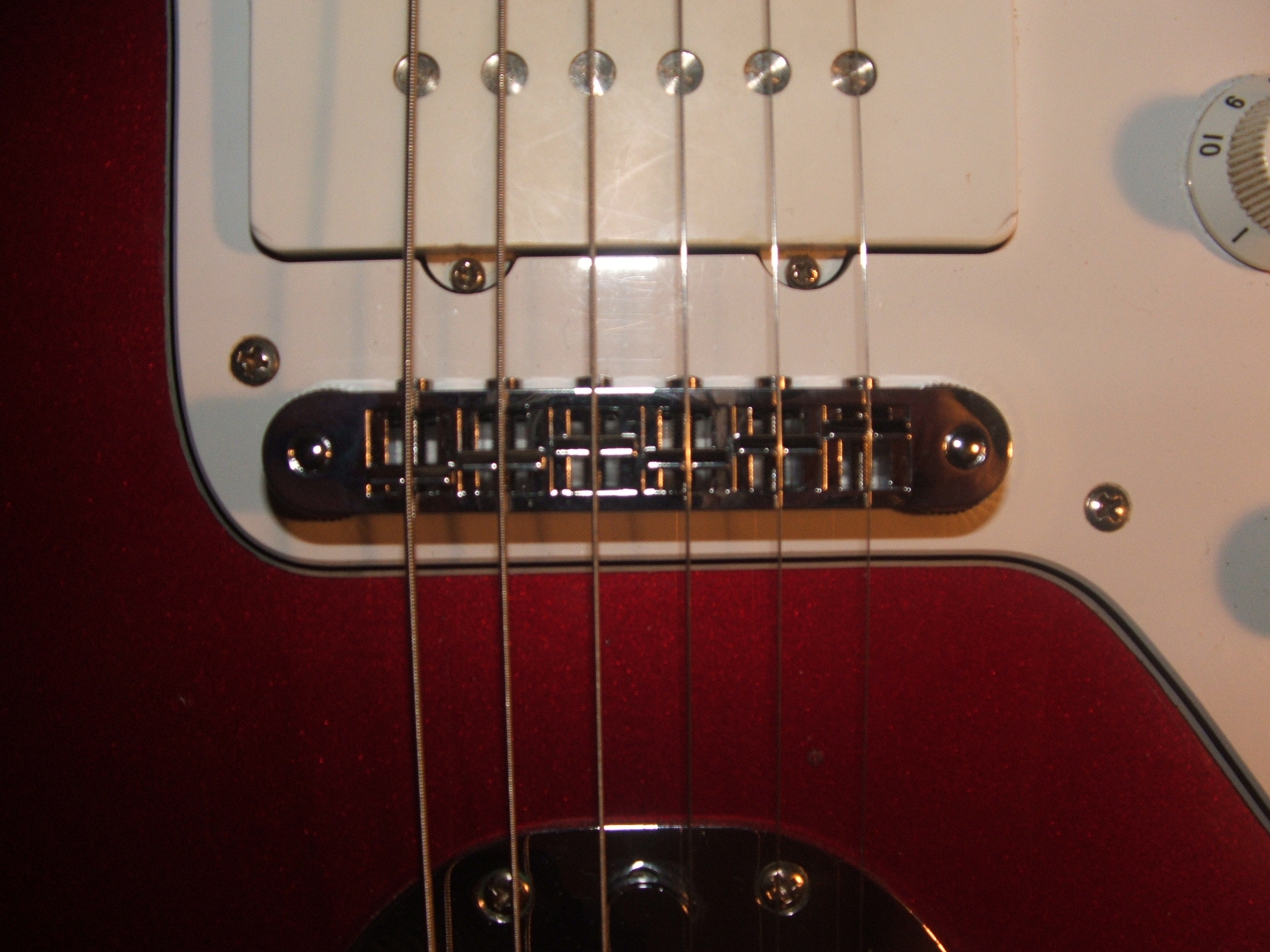 I have shimmed saddles before with slivers of bone, ebony and rosewood depending on bridge material and have not noticed and change in tone, . tune-o-matic bridge for jazzmaster - Fender Jaguar