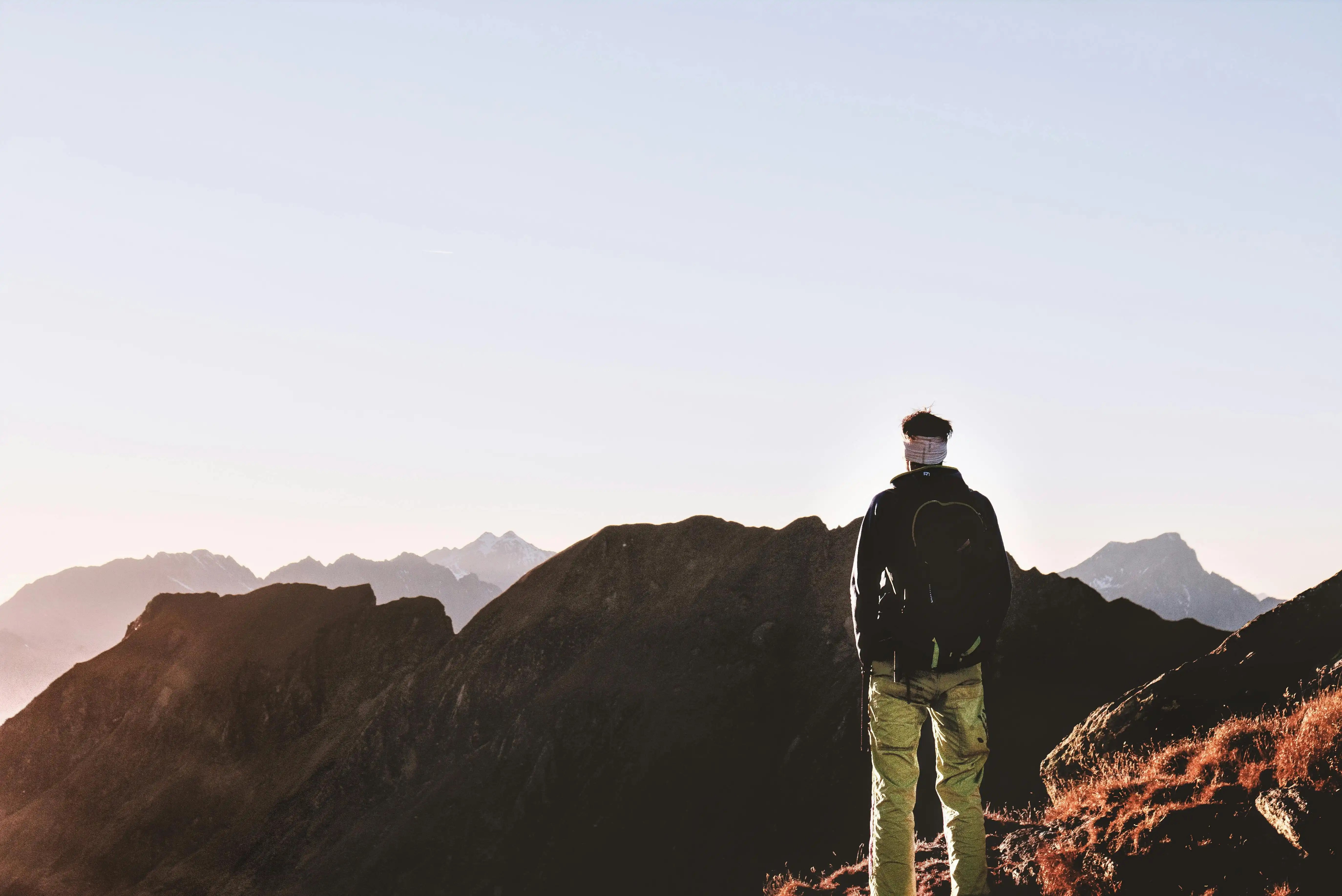 Man at the peak of a mountain
