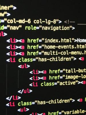 Close-up of vibrant HTML code displayed on a computer screen, showcasing web development and programming.