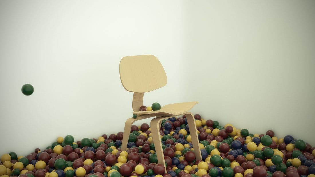 A wooden chair surrounded by colorful balls