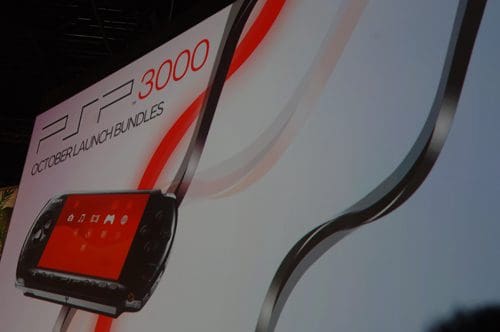 A promotional display featuring a PSP 3000 console with red and black design elements, accompanied by text announcing "October Launch Bundles" in a modern font.