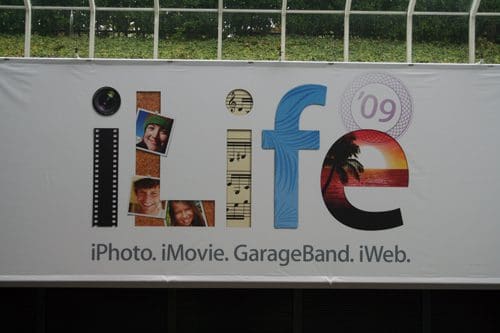 A promotional banner for iLife '09 featuring the stylized word "iLife" with images of people, music notes, and a sunset. Below, the text lists software: "iPhoto, iMovie, GarageBand, iWeb."