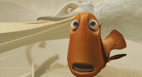 An animated orange fish with large eyes, displaying a surprised expression, is in focus. A shadowy, larger pelican is partly visible in the background, creating a sense of depth in the underwater scene.