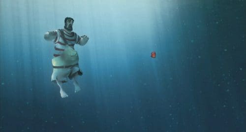 An animated character resembling a strongman in striped swim trunks is floating underwater, with bubbles rising around him. A small red object is visible in the distance, creating a colorful contrast against the deep blue water.