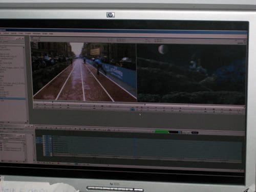 A computer monitor displaying video editing software, showing a split screen. On the left, a rainy track with runners; on the right, a dark scene with a moon and rocks. The timeline and editing tools are visible.
