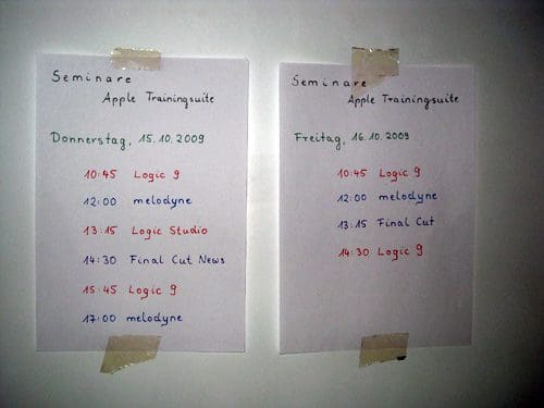 Two sheets of paper taped to a wall, detailing seminar schedules for Apple's training suite. The left sheet lists events for Thursday, October 15, 2009, while the right one displays Friday's schedule, both showing various workshops on Logic and Melodyne.