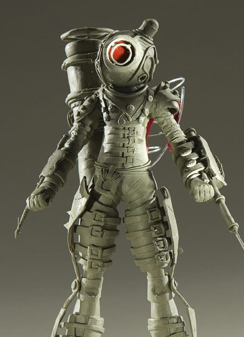 A detailed model of an armored diver wearing a heavy suit with mechanical components, including a prominent helmet with a glowing red lens, and equipped with tools and gadgets, set against a neutral gray background.