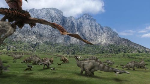 A large pterosaur flying above a herd of various dinosaurs in a lush green valley, with towering mountains in the background under a clear blue sky.