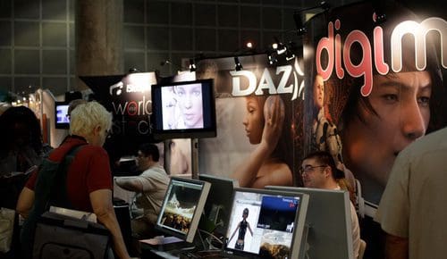 A trade show booth featuring banners for 'DAZ' and 'digim' with images of digital characters. Attendees are engaged with displays on large monitors, showcasing digital art and software. The atmosphere is vibrant and interactive.