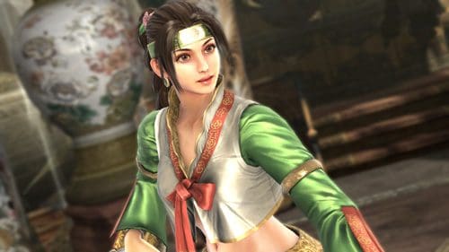 A female character dressed in a vibrant green and white outfit with intricate designs, standing in an elegant setting adorned with ornamental vases. Her hair is styled with decorative elements, and she exudes a confident demeanor.