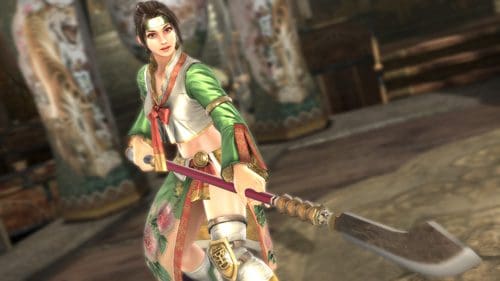 A female warrior stands confidently in a colorful traditional outfit, holding a large, curved weapon. The background features ornate architecture reminiscent of an ancient setting.
